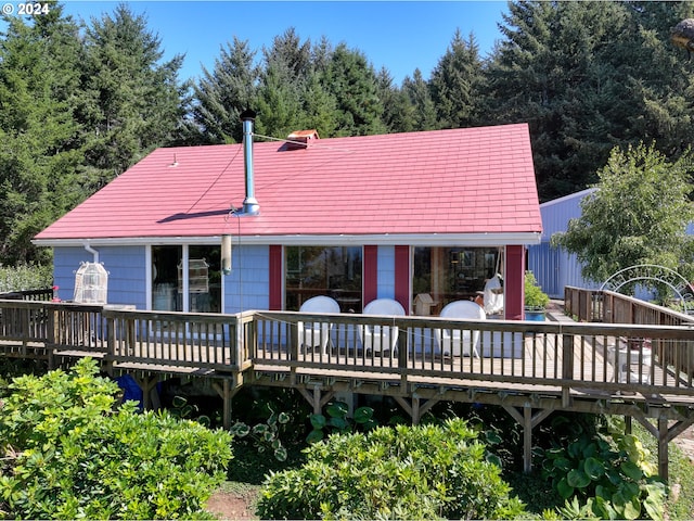 back of house featuring a wooden deck