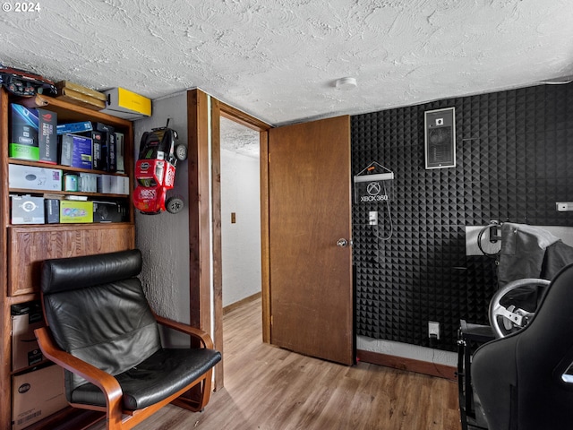 office space with hardwood / wood-style floors and a textured ceiling