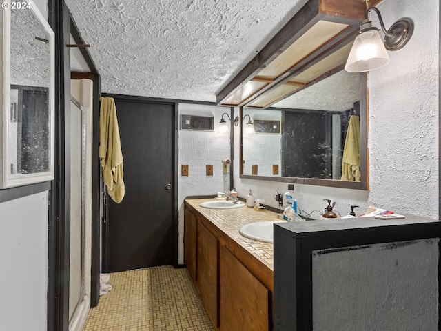 bathroom with vanity and a textured ceiling