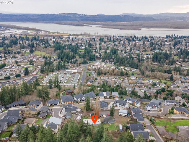 birds eye view of property with a water and mountain view