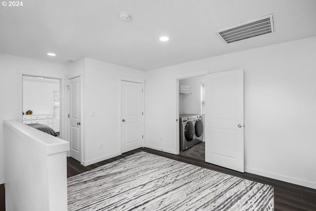 laundry area with washing machine and clothes dryer and dark hardwood / wood-style floors