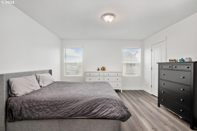 bedroom featuring hardwood / wood-style floors and multiple windows