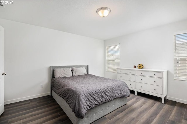 bedroom with dark wood-type flooring