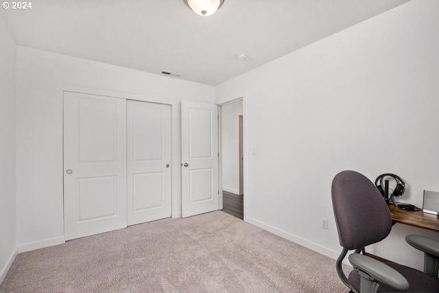 unfurnished office featuring light colored carpet