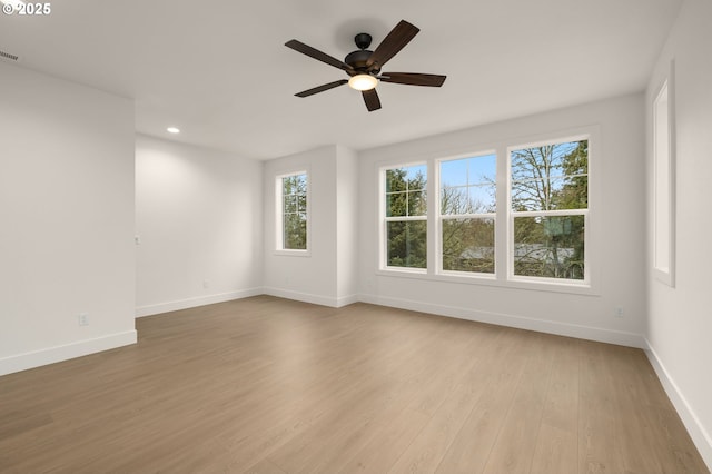 spare room with visible vents, baseboards, light wood-style flooring, ceiling fan, and recessed lighting