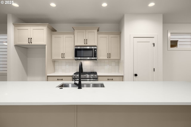 kitchen featuring tasteful backsplash, stainless steel microwave, and recessed lighting