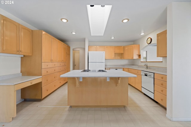 kitchen featuring a kitchen island, white appliances, sink, and light brown cabinets