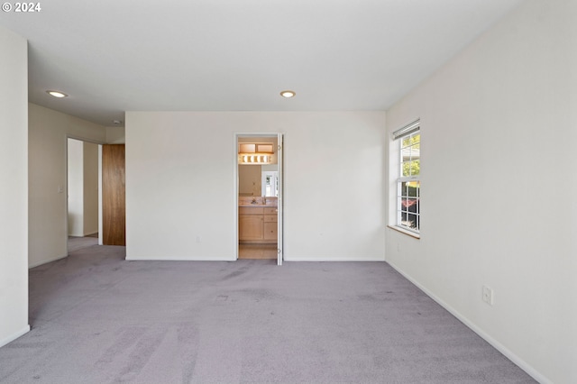 empty room featuring light colored carpet