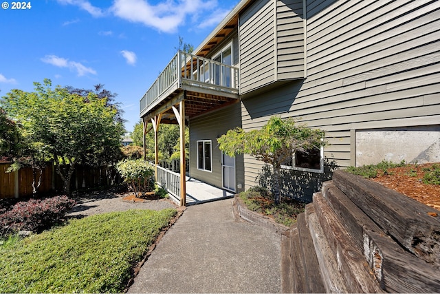 view of property exterior featuring a patio area and a balcony