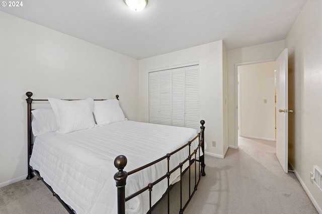 carpeted bedroom with a closet