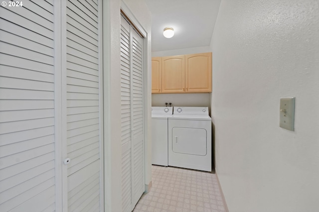 laundry area with cabinets and separate washer and dryer