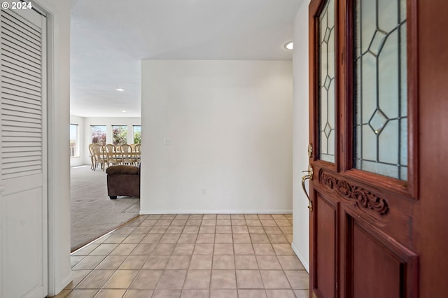 foyer entrance with light colored carpet