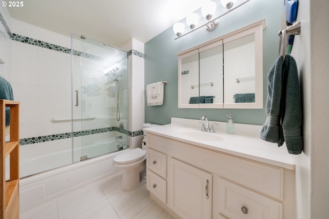full bath with enclosed tub / shower combo, vanity, toilet, and tile patterned floors