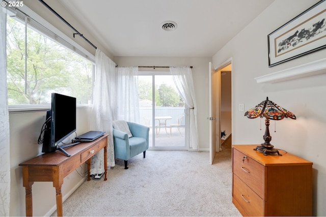living area with carpet floors and visible vents