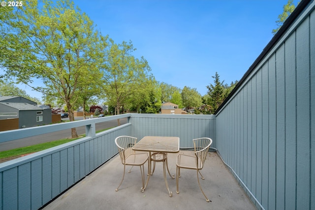 view of patio / terrace featuring a balcony and outdoor dining area