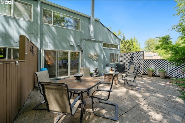 view of patio featuring an outdoor fire pit and cooling unit