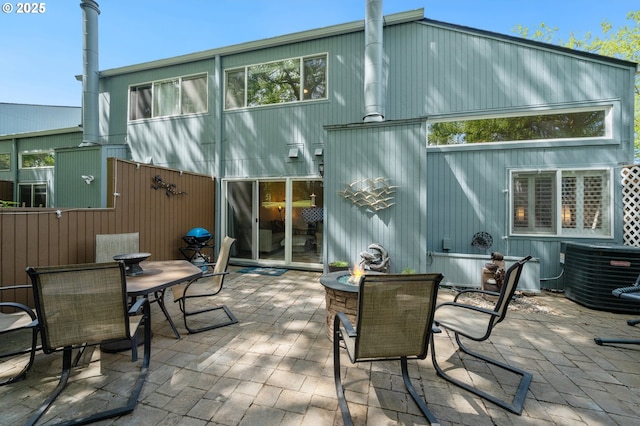 back of house featuring central air condition unit, a patio area, and outdoor dining area
