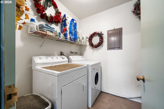 clothes washing area with washing machine and clothes dryer, light carpet, laundry area, and electric panel