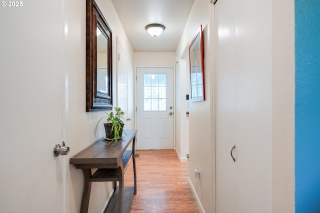 entryway featuring baseboards and light wood finished floors