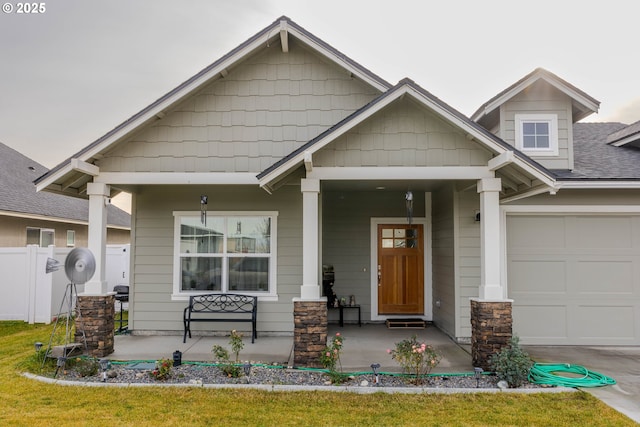 craftsman-style home featuring covered porch and a garage