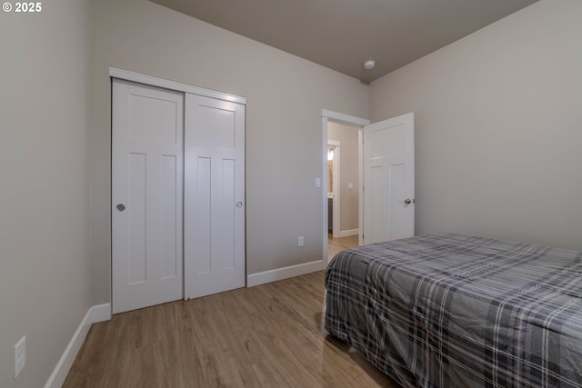 bedroom featuring light wood-type flooring and a closet