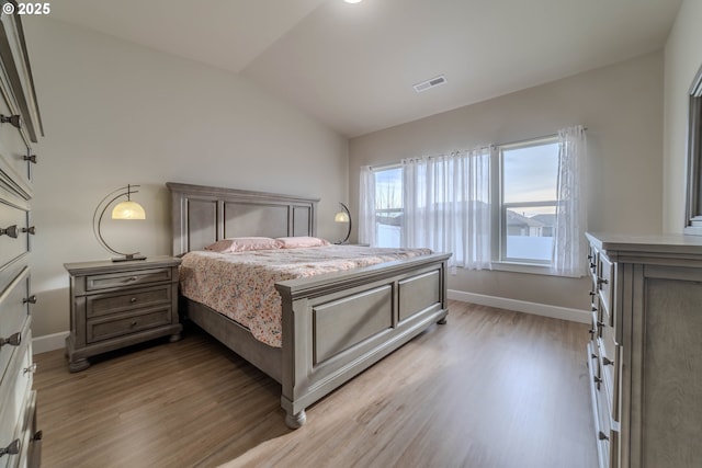 bedroom featuring hardwood / wood-style flooring and vaulted ceiling