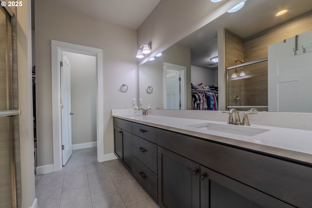 bathroom with tile patterned flooring, vanity, and a shower with shower door