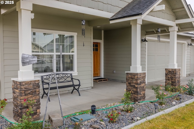 doorway to property featuring a garage and covered porch