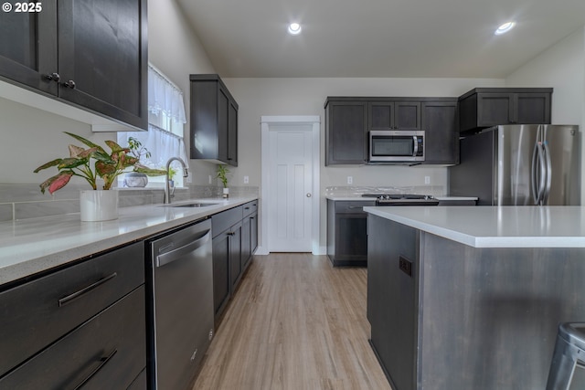 kitchen featuring sink, stainless steel appliances, and light hardwood / wood-style floors