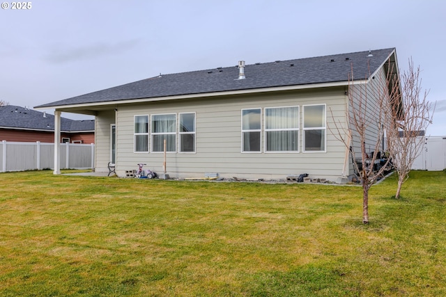 rear view of property with a lawn