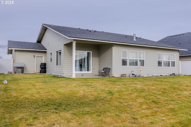 back of house with a lawn