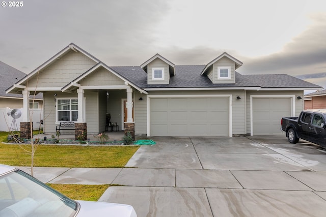 view of front of home with a front yard, a garage, and a porch