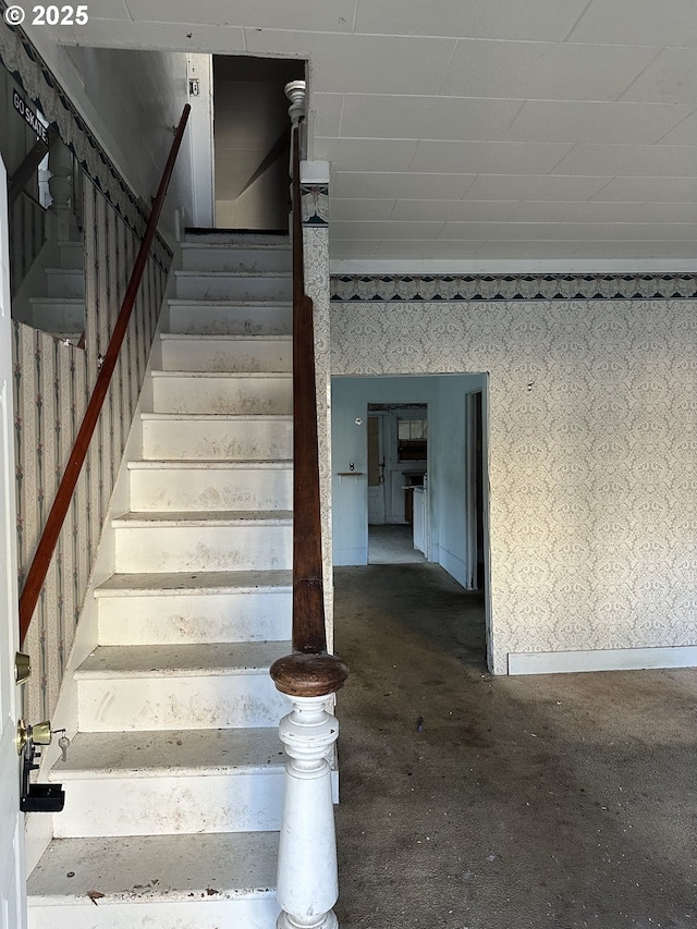 staircase with concrete flooring