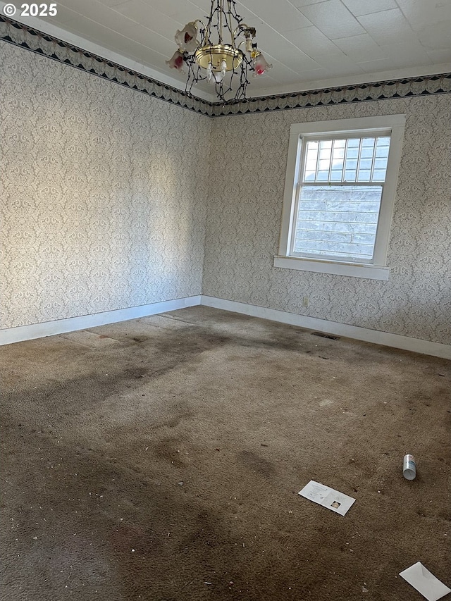 spare room featuring a notable chandelier