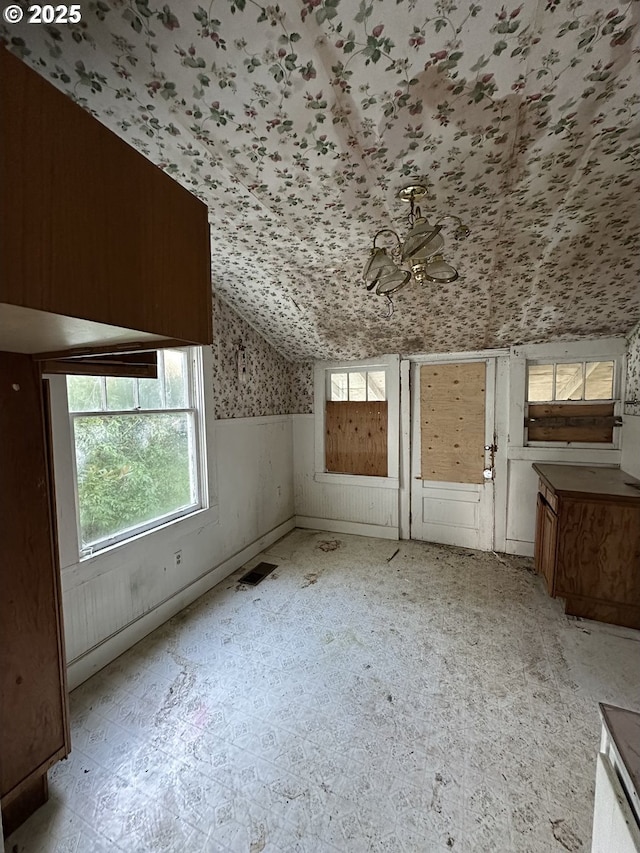 additional living space featuring vaulted ceiling and a healthy amount of sunlight