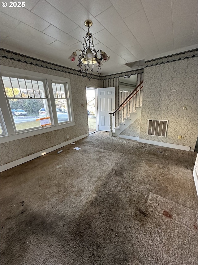 interior space featuring a chandelier and carpet flooring