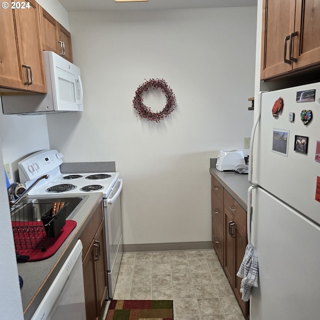 kitchen featuring white appliances and light tile patterned floors