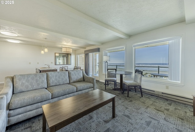 carpeted living room featuring beam ceiling, a wealth of natural light, a baseboard radiator, and a water view