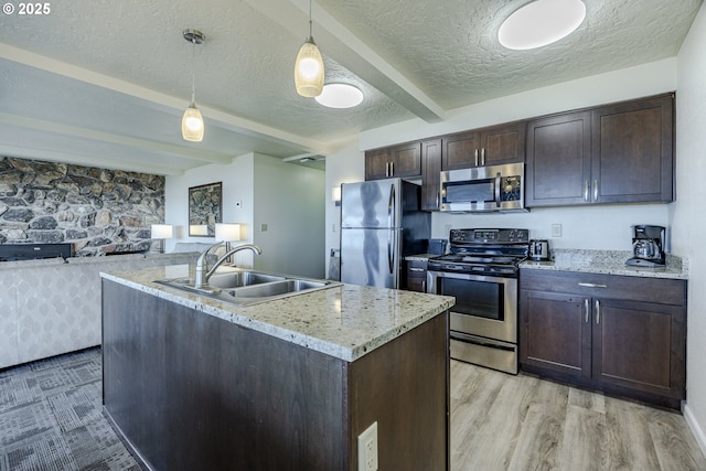 kitchen featuring sink, hanging light fixtures, dark brown cabinets, stainless steel appliances, and beamed ceiling