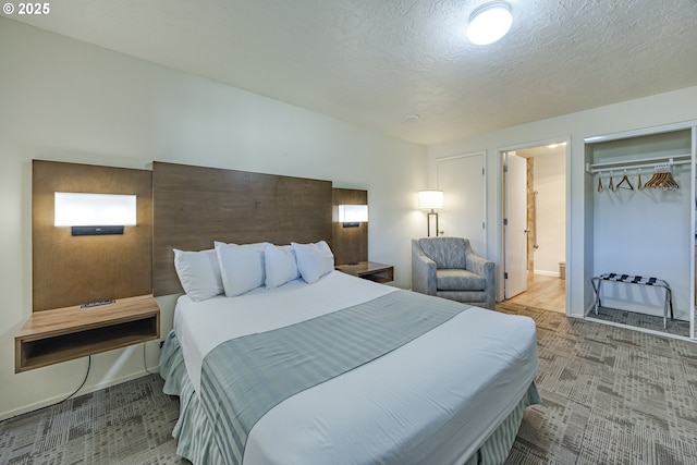 bedroom with carpet floors, a closet, a textured ceiling, and ensuite bathroom