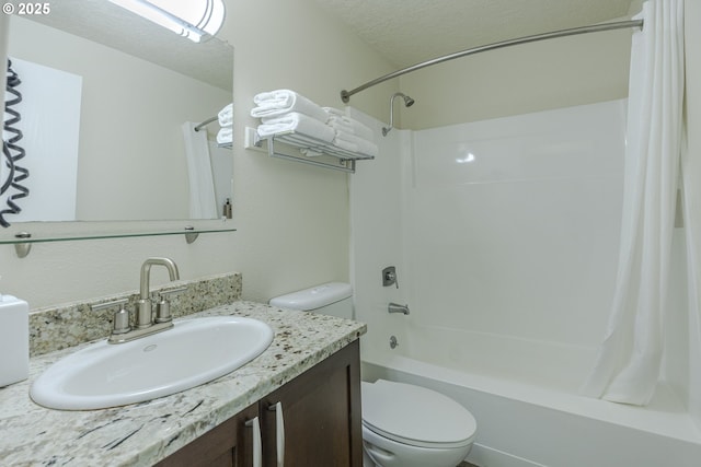 full bathroom with shower / bath combination with curtain, vanity, toilet, and a textured ceiling