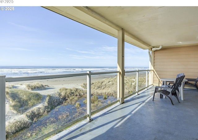 balcony with a view of the beach and a water view