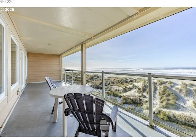 balcony with a beach view and a water view