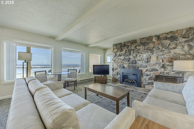 living room with beamed ceiling, plenty of natural light, and a fireplace