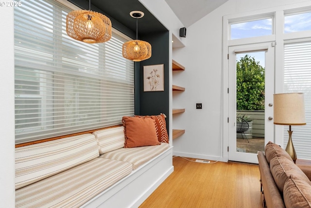 living area featuring light wood-type flooring and lofted ceiling