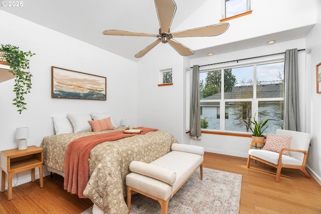 bedroom featuring ceiling fan, vaulted ceiling, and wood-type flooring