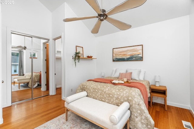 bedroom featuring high vaulted ceiling, ceiling fan, and wood-type flooring