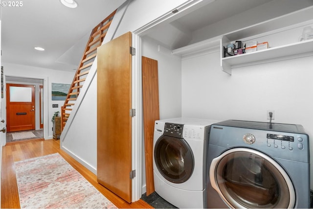 laundry room with separate washer and dryer and light wood-type flooring