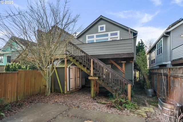 rear view of house with a storage shed