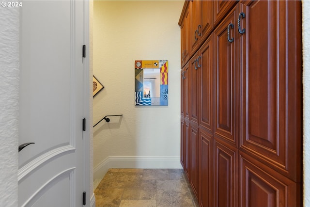 bathroom featuring baseboards and stone finish floor